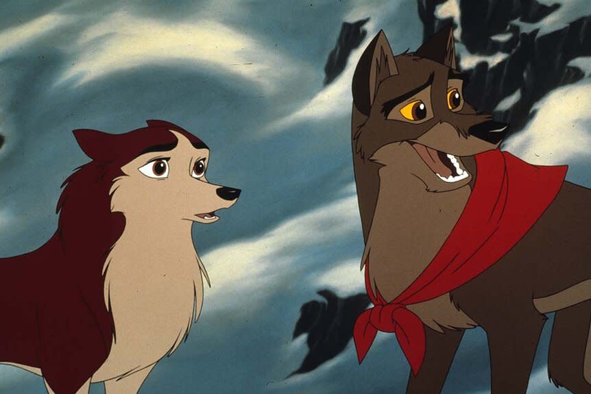 Jenna (Bridget Fonda) speaks to Balto (Kevin Bacon) wearing a red scarf in a snowy landscape in Balto (1995).