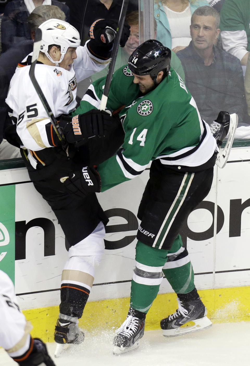 Anaheim Ducks defenseman Bryan Allen (55) and Dallas Stars left wing Jamie Benn (14) tangle against the boards during the first period of Game 6 of a first-round NHL hockey playoff series in Dallas, Sunday, April 27, 2014. (AP Photo/LM Otero)