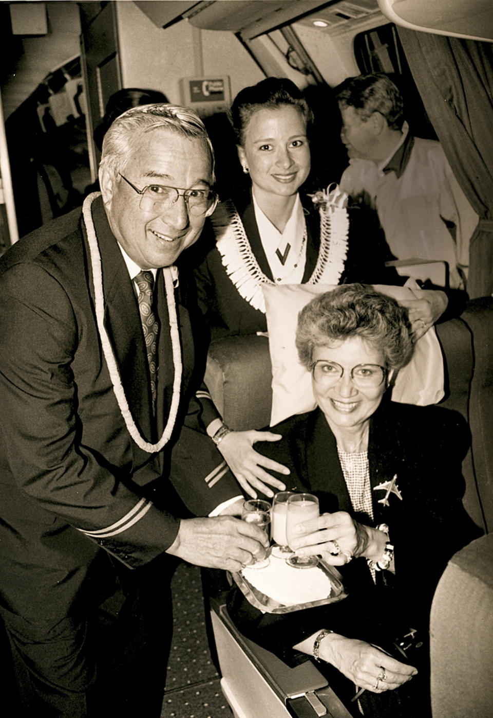 In this 1992 photo provided by his family, Ron Akana poses in an airplane with his wife Betsy and his daughter Jean Akana-Lewis. Akana, 83, worked his last route over the weekend on a United Airlines flight from Denver to Kauai, ending his career in the state where it began. Hawaii, however, wasn't his final stop. His destination is retirement in Boulder, Colo., where he has been living since 2002 to be closer to his grandchildren. He spent his first few days of retirement writing thank-you notes to well-wishers. Guinness World Records sent Akana a plaque recognizing him as the longest-serving flight attendant. He's been told he'll appear in the record book in October. (AP Photo/Courtesy of Jean Akana-Lewis)