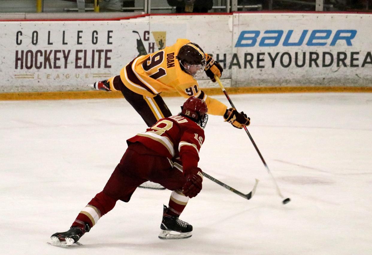 Arizona State center Josh Doan shoots from the faceoff circle as Denver forward Cole Guttman skates over during Friday's game at Oceanside Ice Arena in Tempe. 