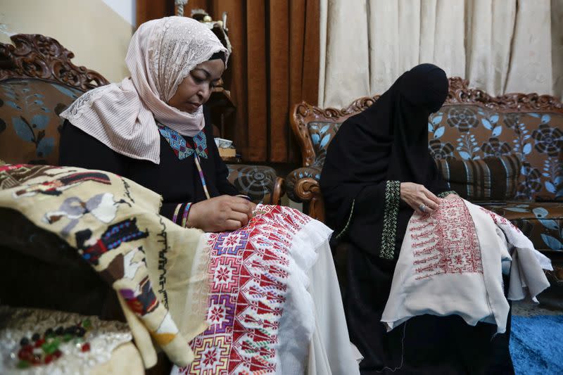 Um Zeid, 47 year-old, and Khawla 48 year-old, Palestinian refugees women living in Jordan embroider a traditional Palestinian dresses for customers at Al-Baqaa Palestinian refugee camp, near Amman