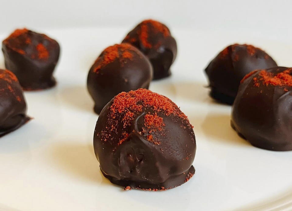 This image shows a plate of chocolate truffles. Rather than spending on store-bought chocolates for Valentine’s Day, make them together as a fun way to spend the evening with your Valentine. (Jennifer Bell via AP)