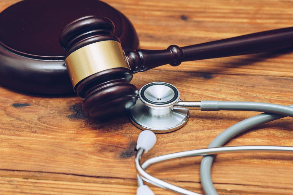 A stock photo showing a judge's gavel and a doctor's stethoscope.