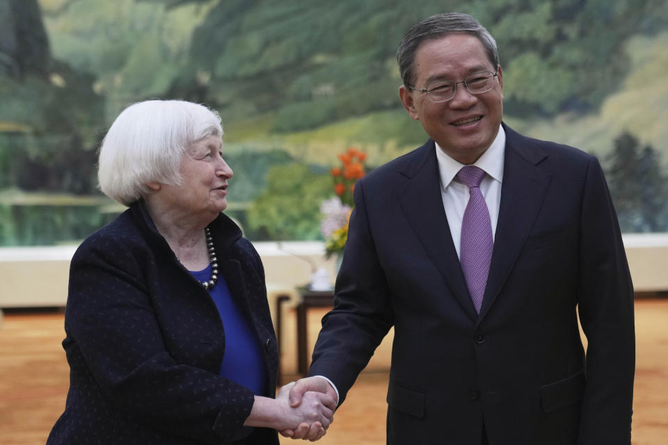 U.S. Treasury Secretary Janet Yellen, left, shakes hands with Chinese Premier Li Qiang at the Great Hall of the People in Beijing, China, Sunday, April 7, 2024. Yellen, who arrived later in Beijing after starting her five-day visit in one of China's major industrial and export hubs, said the talks would create a structure to hear each other's views and try to address American concerns about manufacturing overcapacity in China. (AP Photo/Tatan Syuflana, Pool)