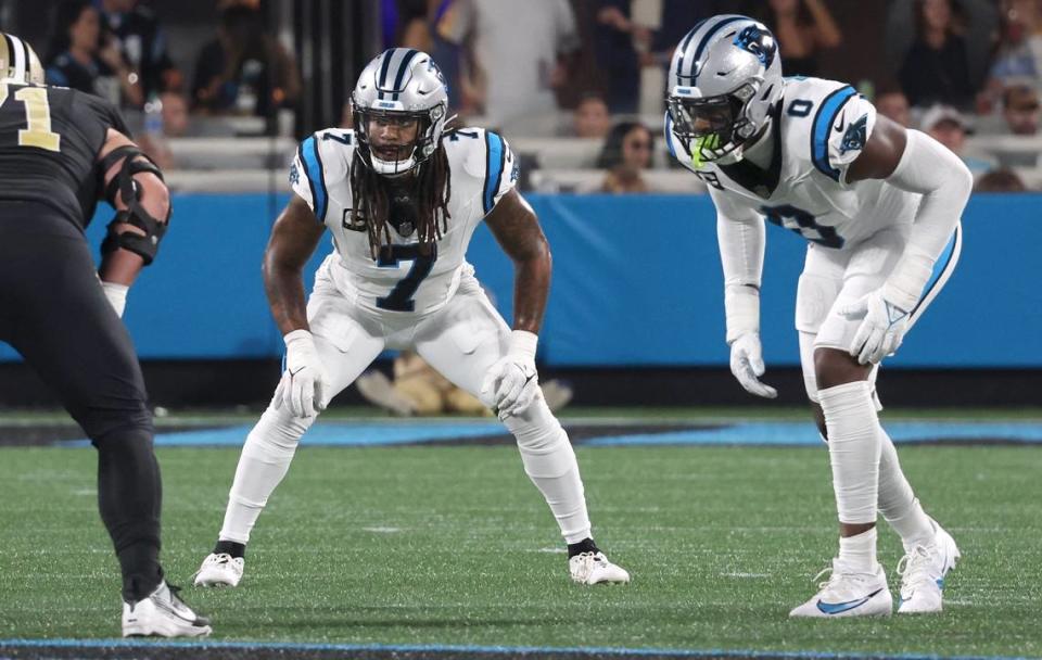 Carolina Panthers linebacker Shaq Thompson, center and linebacker Brian Burns, right, wait for the ball to be snapped during first-quarter action against the New Orleans Saints at Bank of America Stadium on Monday, September 18, 2023. The Panthers lost to the Saints 20-17.