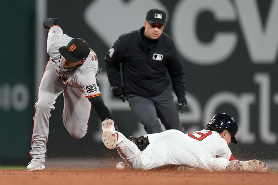 Boston Red Sox's Bobby Dalbec steals second base as San Francisco Giants shortstop Nick Ahmed, left, misses the tag during the seventh inning of a baseball game, Tuesday, April 30, 2024, in Boston. (AP Photo/Michael Dwyer)