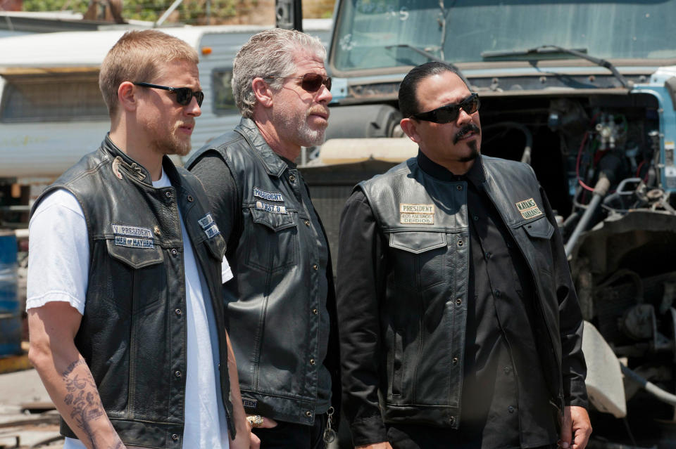 Three men in sunglasses and leather vests