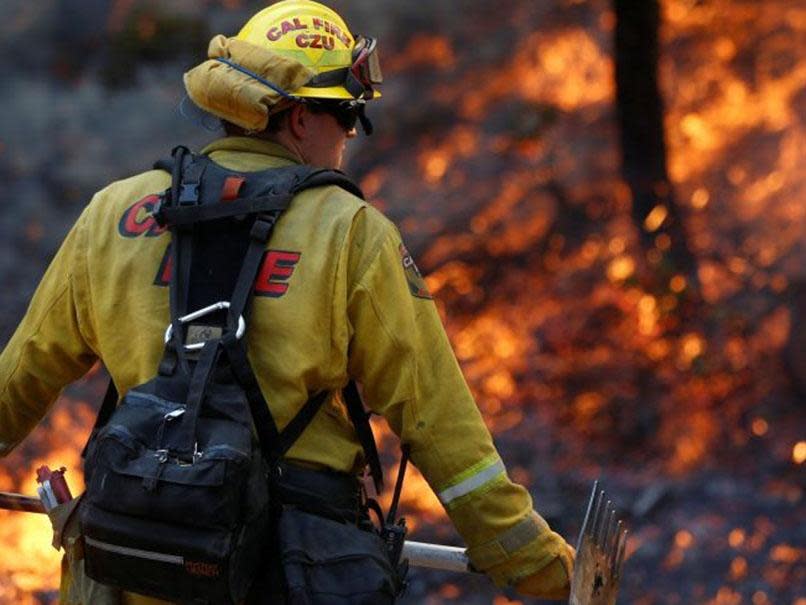 Firefighters work to defend homes from an approaching wildfire in Sonoma, California: REUTERS