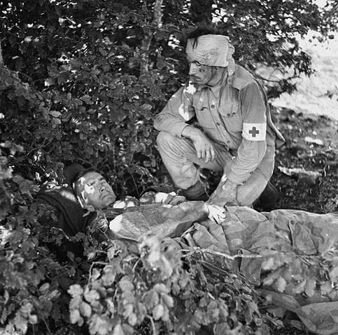 Captain A.W. Hardy, a medical officer with the West Nova Scotia Regiment, lies wounded, with Pte. W.E. Dexter, a unit stretcher-bearer who was wounded in the head, in Santa-Cristina D'Aspromonte, Italy, on Sept. 8, 1943.