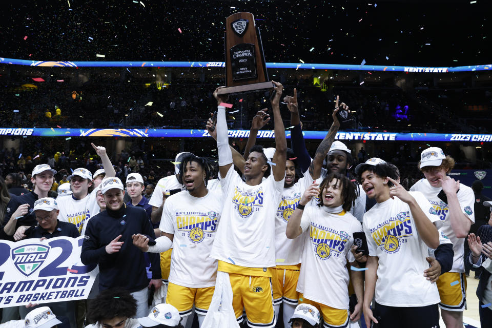 Kent State players celebrate after defeating Toledo in an NCAA college basketball game to win the championship of the Mid-American Conference Tournament, Saturday, March 11, 2023, in Cleveland. (AP Photo/Ron Schwane)