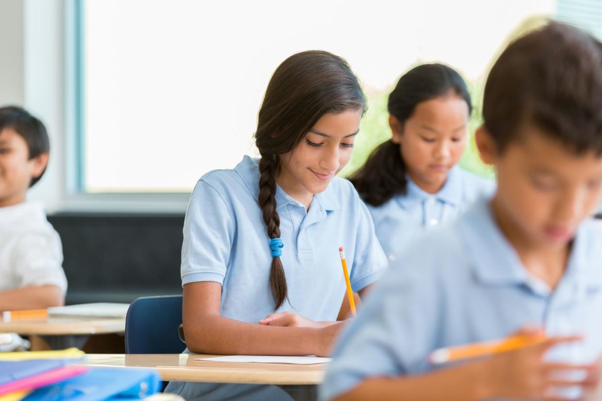 students in uniform working on assignment