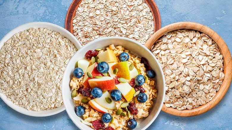 Top-down view of oatmeal and different types of oats in bowls