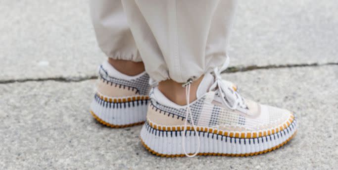 a woman wearing chloe designer sneakers for women on the street in munich in a roundup of the best designer sneakers for women 2023