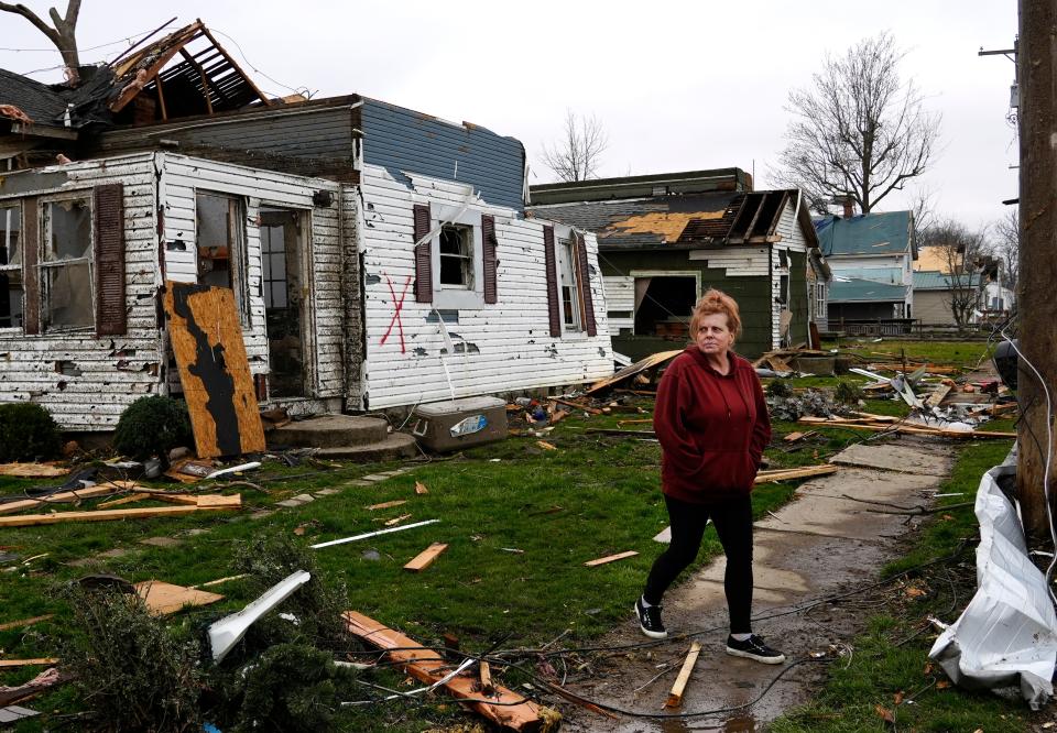 Tanya Gause walks away from her home in Lakeview, Ohio, after collecting what she could following a tornado the night before, Friday, March 15, 2024. Tanya and her husband, Travis, sheltered in their bathroom with their pets. They are still missing one cat.
