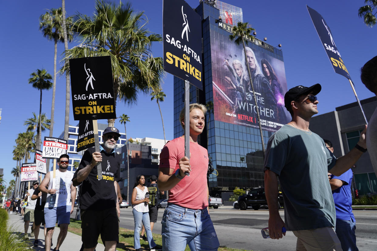 Striking writers and actors take part in a rally outside Netflix studio in Los Angeles on Friday, July 14, 2023. This marks the first day actors formally joined the picket lines, more than two months after screenwriters began striking in their bid to get better pay and working conditions. (AP Photo/Chris Pizzello)