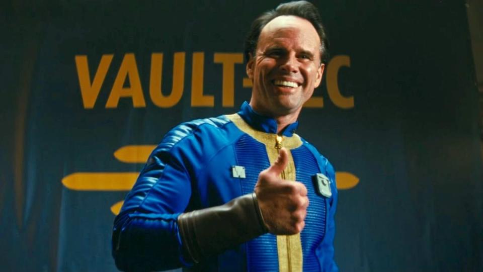 Cooper Howard becomes Vault Boy in blue and yellow vault-tec suit with thumbs up