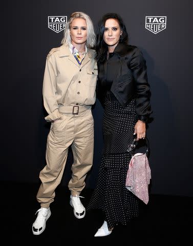 <p>Brian Ach/Getty </p> Ashlyn Harris and Ali Krieger at the TAG Heuer launch event in March 2020