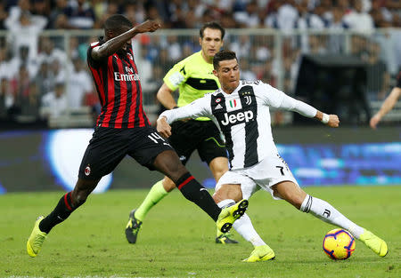 Soccer Football - Italian Super Cup - Juventus v AC Milan - King Abdullah Sports City, Jeddah, Saudi Arabia - January 16, 2019 AC Milan's Tiemoue Bakayoko attempts to block a shot from Juventus' Cristiano Ronaldo REUTERS/Faisal Al Nasser