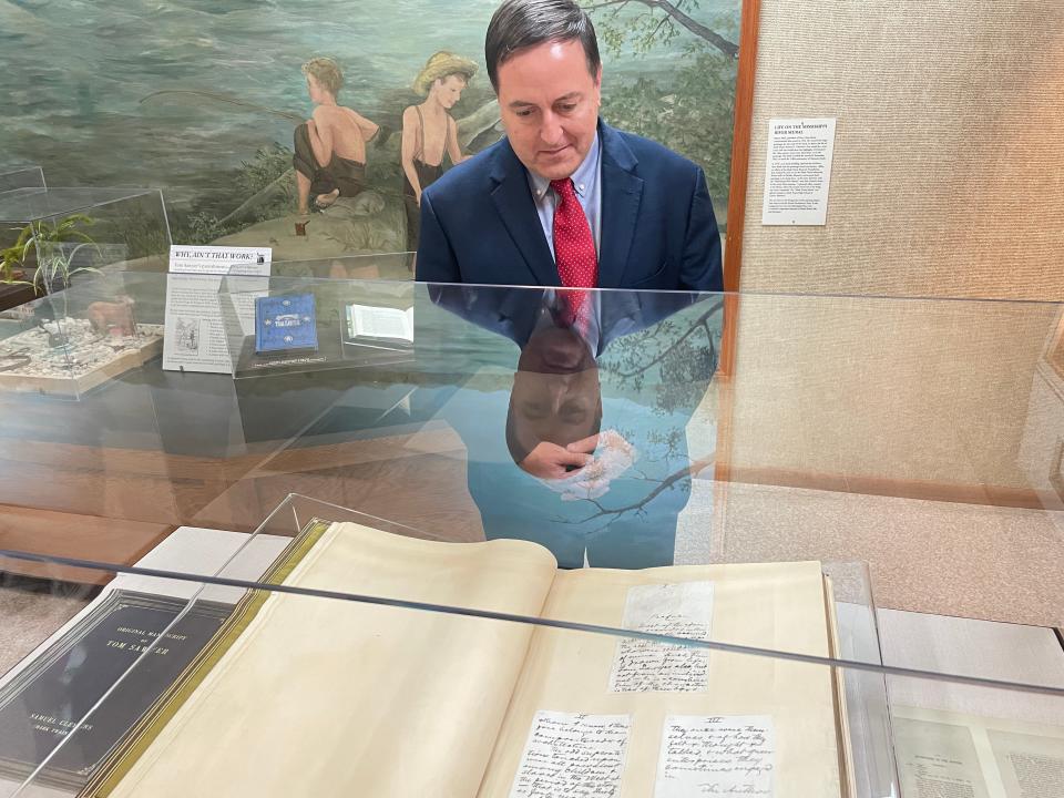 Secretary of State Jay Ashcroft admires Mark Twain's newly restored original manuscript of "The Adventures of Tom Sawyer," which was unveiled at the Mark Twain Birthplace State Historic Site in Florida, Mo. on Sept. 28, 2023.