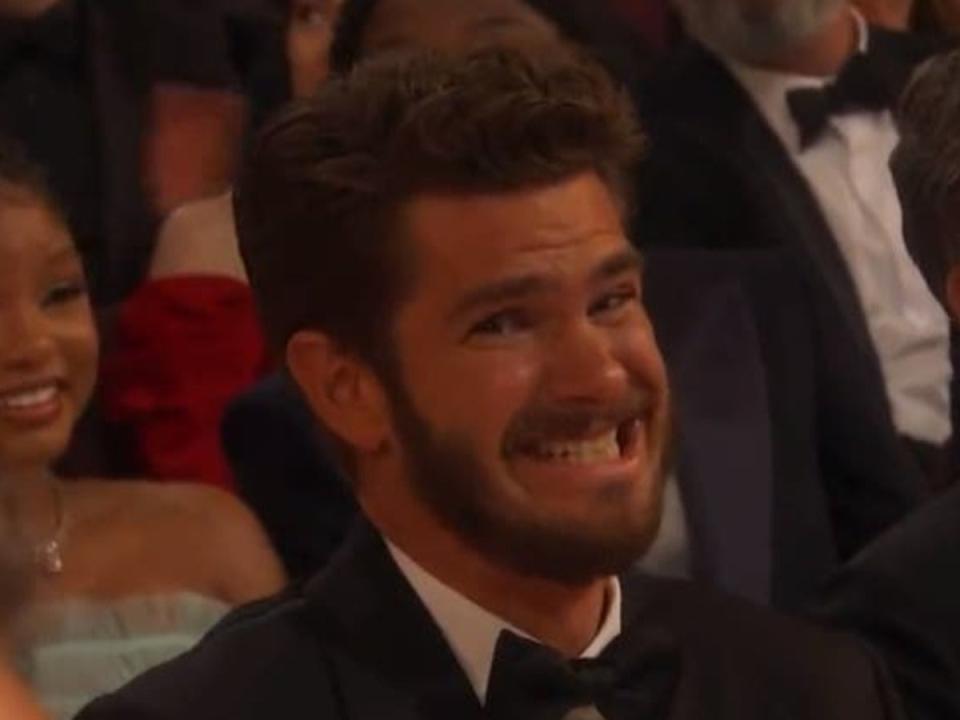 Andrew Garfield awkwardly grimacing at the 2023 Oscars (ABC)
