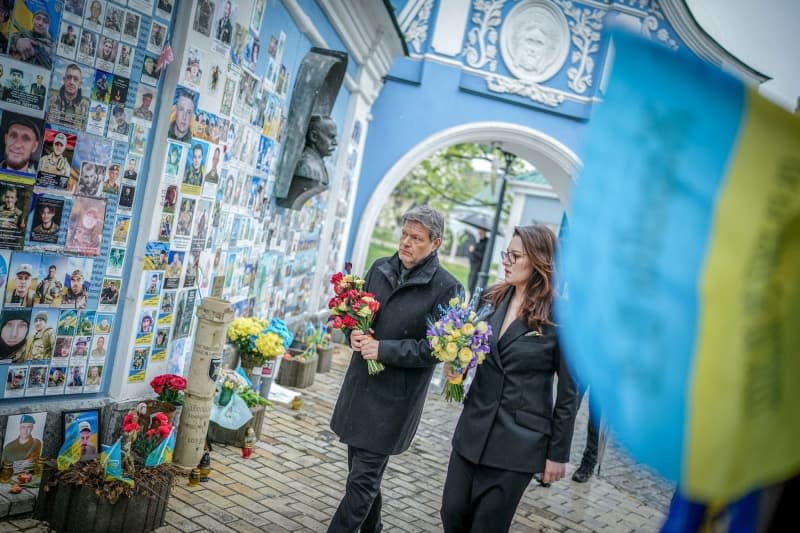 German Minister for Economic Affairs and Climate Protection Robert Habeck lays flowers at the memorial wall for the soldiers who died in the war. Kay Nietfeld/dpa