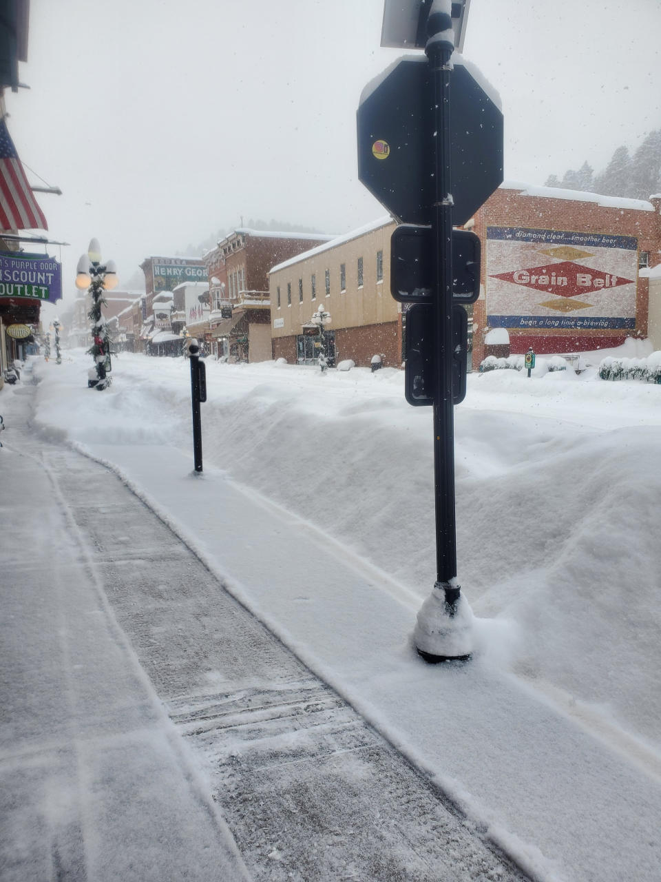 This image provided by Historic Bullock Hotel Manager Vicki Weekly shows snow piled in front of the Historic Bullock Hotel in Deadwood, S.D., on Tuesday, Dec. 13, 2022. (Vicki Weekly via AP)