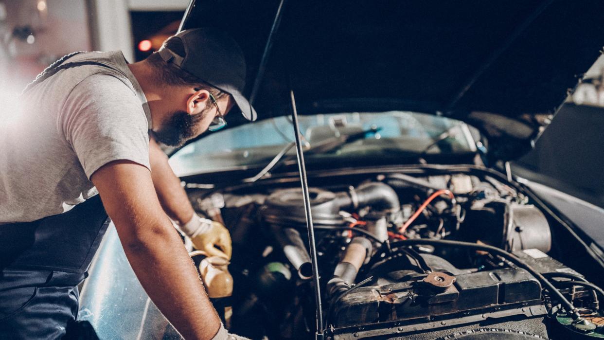 Man working on repair of old timer.