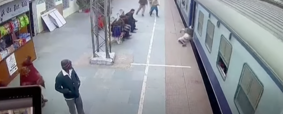 Rescue of a man trapped between a moving train and platform