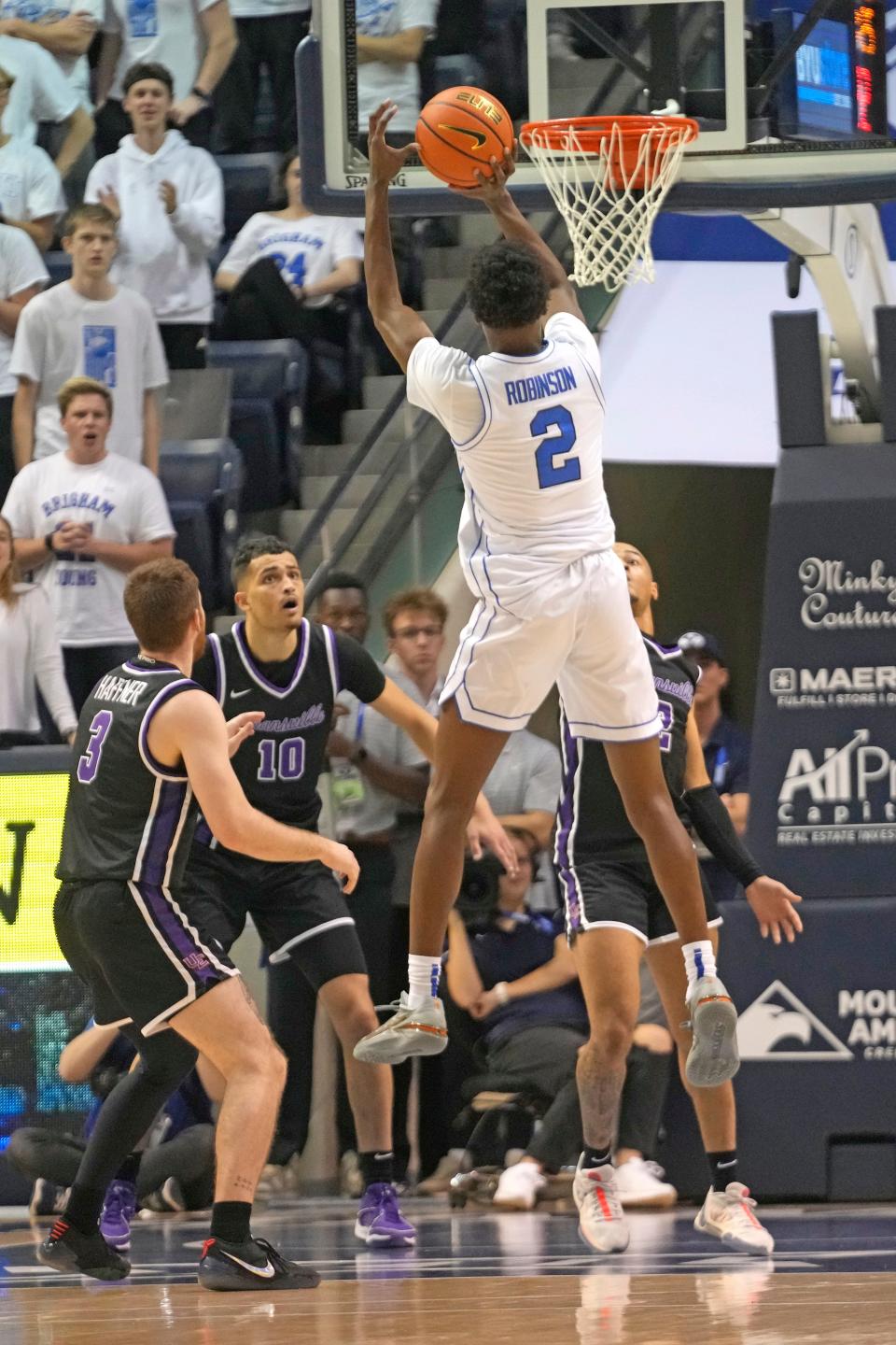 BYU guard Jaxson Robinson (2) shoots as Evansville guard Cameron Haffner (3) defends during the first half of an NCAA college basketball game Tuesday, Dec. 5, 2023, in Provo, Utah. (AP Photo/Rick Bowmer)