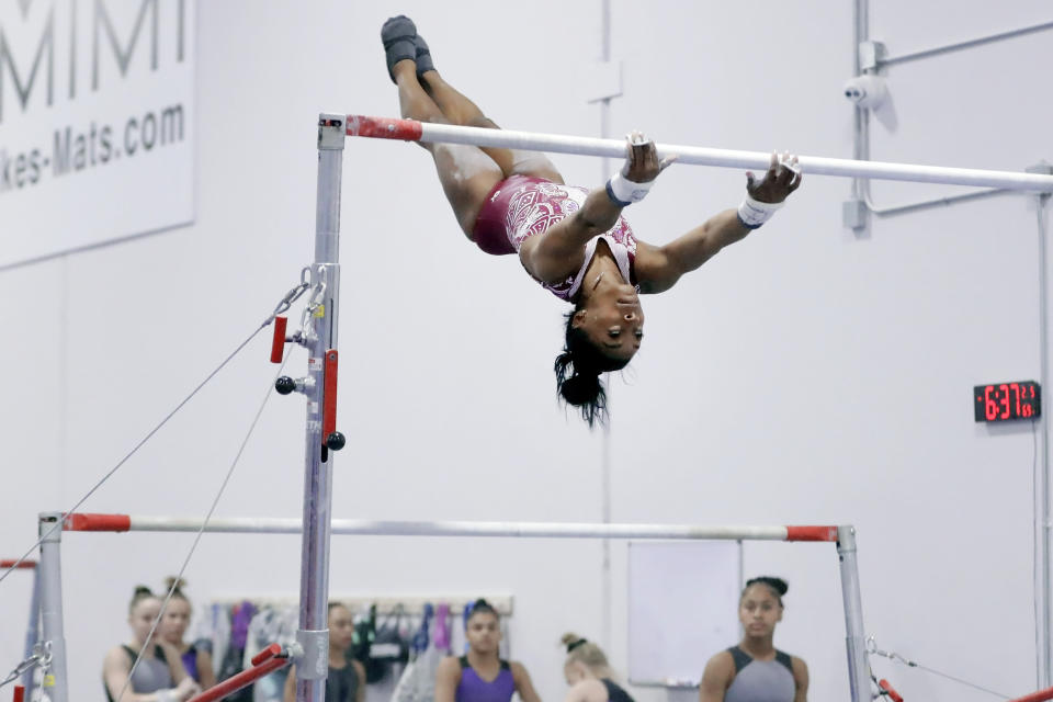 Simone Biles works on the parallel bars during training at the Stars Gymnastics Sports Center in Katy, Texas, Monday, Feb. 5, 2024. Biles begins preparations for the Paris Olympics when she returns to competition at the U.S. Classic in Hartford, Connecticut on Saturday. Biles, who cited mental health concerns while removing herself from several competitions at the Tokyo Olympics, says she is better prepared for the pressure competing presents this time around. (AP Photo/Michael Wyke)