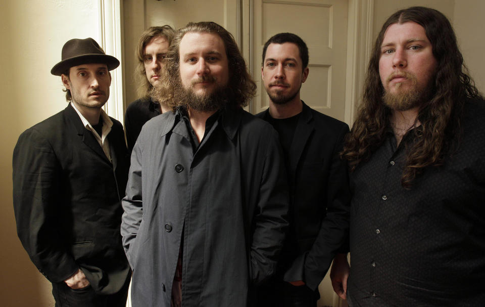 In this Wednesday, April 13, 2011 photo, members of My Morning Jacket, from left, Bo Koster, Carl Broemel, Jim James, Tom Blankenship and Patrick Hallahan pose for a photograph in Louisville, Ky. The band is scheduled to play at the 2012 Newport, R.I., Folk Festival. (AP Photo/Ed Reinke)