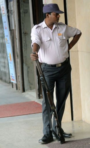 An Indian security guard stands with a shotgun at the entrance to a jewellery shop in New Delhi. Several mass shootings in the capital have made front-page news in recent weeks and led to renewed scrutiny of warnings from campaigners that a gun culture is gradually taking root