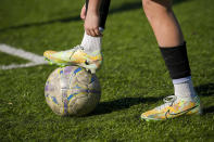 A child rests his leg on a soccer ball during a soccer training session in Kyiv, Ukraine, Wednesday, March 27, 2024. Ukraine, Georgia and Poland are going to the 2024 European Championship after bringing late drama to win emotional qualifying playoffs on Tuesday. (AP Photo/Vadim Ghirda)