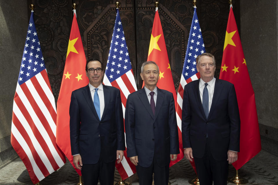 CORRECTS SPELLING TO STEVEN INSTEAD OF STEVE - Chinese Vice Premier Liu He, center, poses with U.S. Trade Representative Robert Lighthizer, right, and Treasury Secretary Steven Mnuchin pose for photos before holding talks at the Xijiao Conference Center in Shanghai Wednesday, July 31, 2019. (AP Photo/Ng Han Guan, Pool)