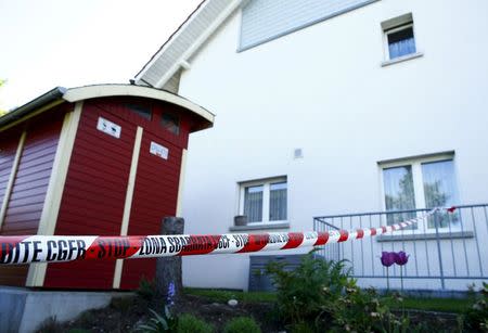 A police ribbon is seen in front of a house in Wuerenlingen, Switzerland May 10, 2015. REUTERS/Ruben Sprich