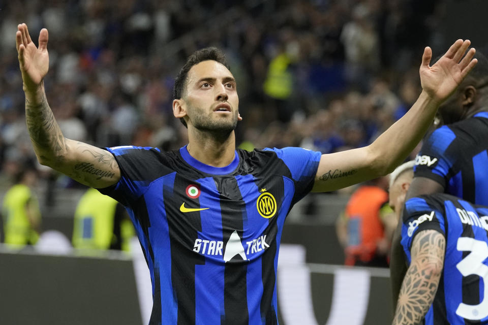 Inter Milan's Hakan Calhanoglu celebrates after scoring his side's second goal during the Italian Serie A soccer match between Inter Milan and Cagliari at the San Siro stadium in Milan, Italy, Sunday, April 14, 2024. (AP Photo/Antonio Calanni)