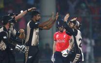 Cricket - England v New Zealand - World Twenty20 cricket tournament semi-final - New Delhi, India - 30/03/2016. New Zealand's Ish Sodhi (C) is congratulated by his teammates after he took the wicket of England's captain Eoin Morgan. REUTERS/Adnan Abidi