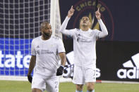 New England Revolution forward Gustavo Bou (7), right, celebrates his goal against the Chicago Fire during the first half of an MLS soccer match in Chicago, Saturday, April 17, 2021. (AP Photo/Mark Black)