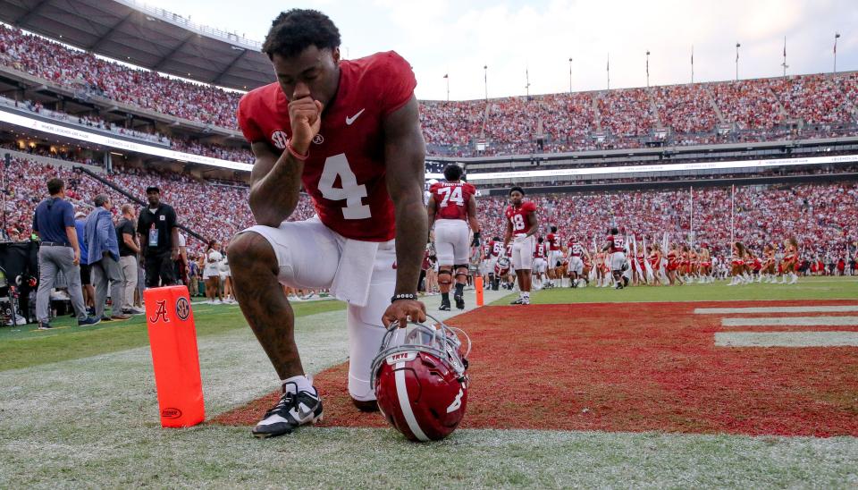 Alabama Crimson Tide quarterback Jalen Milroe (4) kneels in prayer in the end zone on Sept. 9, 2023, before the Crimson Tide game with Texas at Bryant-Denny Stadium.