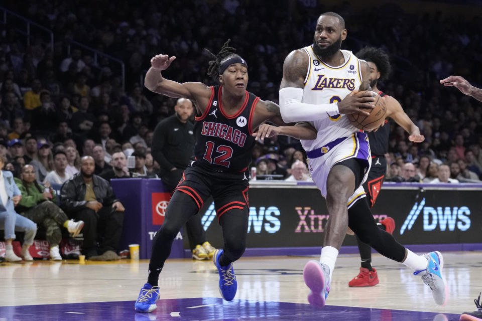 Los Angeles Lakers forward LeBron James drives to the basket past Chicago Bulls guard Ayo Dosunmu (12) during the second half of an NBA basketball game, Sunday, March 26, 2023, in Los Angeles. (AP Photo/Marcio Jose Sanchez)