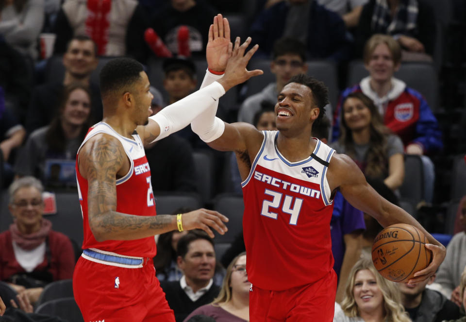 Sacramento Kings' Kent Bazemore, left, and Buddy Hield celebrate in the closing moments of the Kings' 122-102 win over the San Antonio Spurs in an NBA basketball game in Sacramento, Calif., Saturday, Feb. 8, 2020. (AP Photo/Rich Pedroncelli)