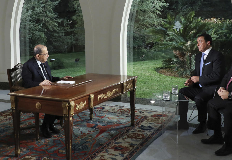 FILE - In this Nov. 12, 2019 file photo, provided by Lebanon's official government photographer Dalati Nohra, Sami Kleib, right, a former journalist from Al-Mayadeen satellite channel, interviews Lebanese President Michel Aoun, left, at the presidential palace, in Baabda, east of Beirut, Lebanon. Kleib resigned from Al-Mayadeen last month, saying the reason behind his move was that he was “closer to the people than the authorities.” (Dalati Nohra via AP, File)