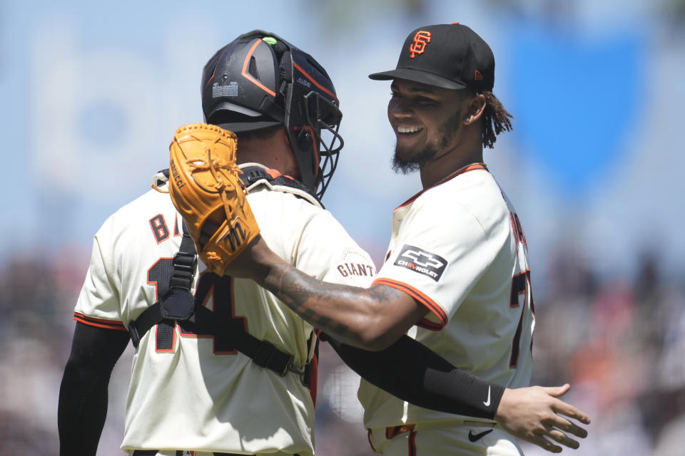 San Francisco Giants catcher Patrick Bailey, left, celebrates with pitcher Camilo Doval after the Giants defeated the Houston Astros in a baseball game in San Francisco, Wednesday, June 12, 2024. (AP Photo/Jeff Chiu)