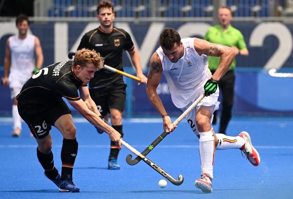 Belgium's Simon Pierre Gougnard (R) is tackled by Germany's Niklas Bosserhoff during their men's pool B match of the Tokyo 2020 Olympic Games field hockey competition, at the Oi Hockey Stadium in Tokyo on July 26, 2021. (Photo by Ina Fassbender / AFP) (Photo by INA FASSBENDER/AFP via Getty Images)