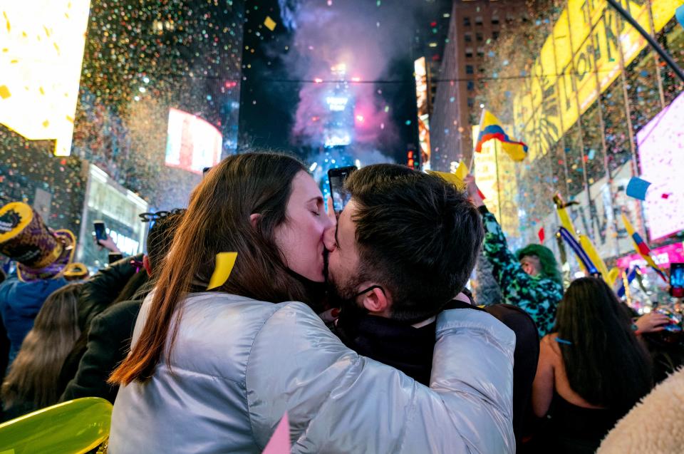 Irene Mayoral, left, and Gerald Nuell of Spain kiss as they celebrate in New York City's Times Square early on Saturday, Jan. 1, 2022, as they attend New Year's Eve celebrations. The couple got engaged Friday.