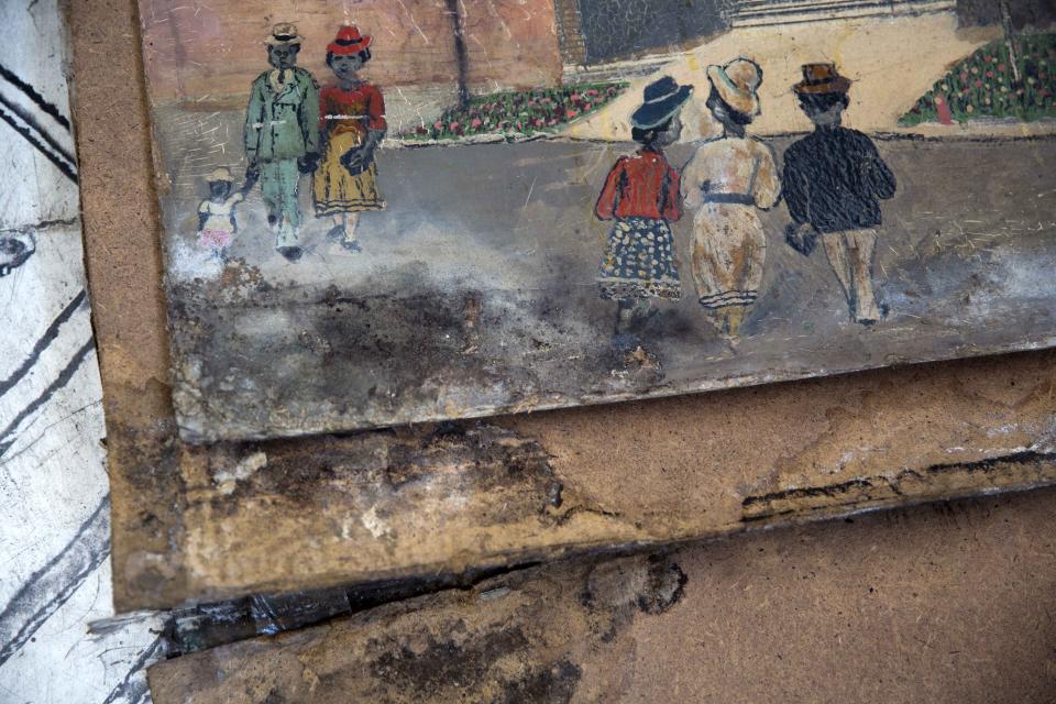 This July 4, 2019 photo, shows the damage on a painting caused by 2010 earthquake 2010, at the Musée d'Art du Collège Saint Pierre, in Port-au-Prince, Haiti. Louis Du Bois, a small, 91-year-old man who is president of the Museum of Haitian Art estimates that the museum needs $50,000 to reopen, noting that the roof has to be repaired, the electricity fixed and the majority of the more than 30 paintings that were extensively damaged in the quake restored. (AP Photo/Dieu Nalio Chery)