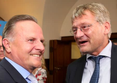 Berlin top candidate of the anti-immigration party Alternative for Germany (AfD) Georg Pazderski welcomes AfD co-leader Joerg Meuthen (R) before the first exit polls after the Berlin city-state elections, Germany September 18, 2016. REUTERS/Fabrizio Bensch