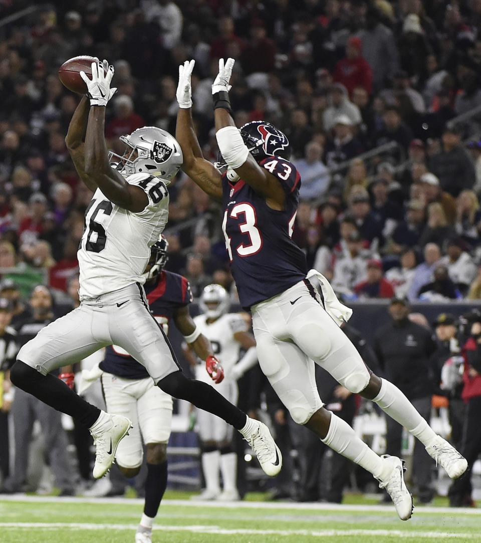 <p>Oakland Raiders wide receiver Johnny Holton (16) misses the catch against Houston Texans strong safety Corey Moore (43) during the second half of an AFC Wild Card NFL game Saturday, Jan. 7, 2017, in Houston. The Houston Texans won 27-14. (AP Photo/Eric Christian Smith) </p>