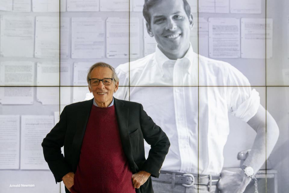 Author and biographer Robert Caro stands beside an image of his younger self after touring a permanent exhibit in his honor, "Turn Every Page": Inside the Robert A. Caro Archive, at the New York Historical Society Museum & Library in New York on Wednesday, Oct. 20, 2021. (AP Photo/John Minchillo)