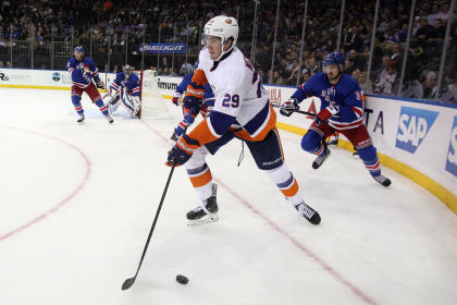 Oct 14, 2014; New York, NY, USA; New York Islanders center Brock Nelson (29) skates with the puck in front of New York Rangers defenseman Kevin Klein (8) during the third period at Madison Square Garden. The Islanders won 6-3. (Brad Penner-USA TODAY Sports)